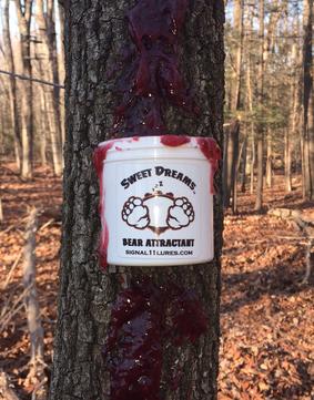 A tree with blood on it and a sticker on the side of it.