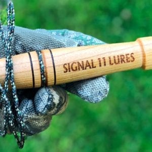 A wooden stick with the words signal 1 1 lures on it.
