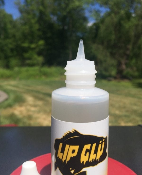 A bottle of up glue sitting on top of a table.