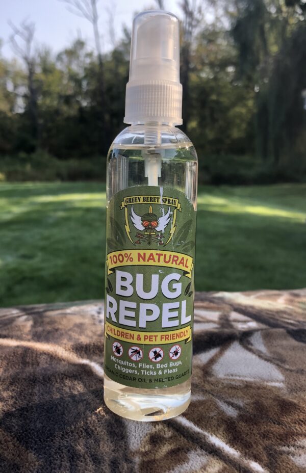 A bottle of bug repellent sitting on top of a patio.