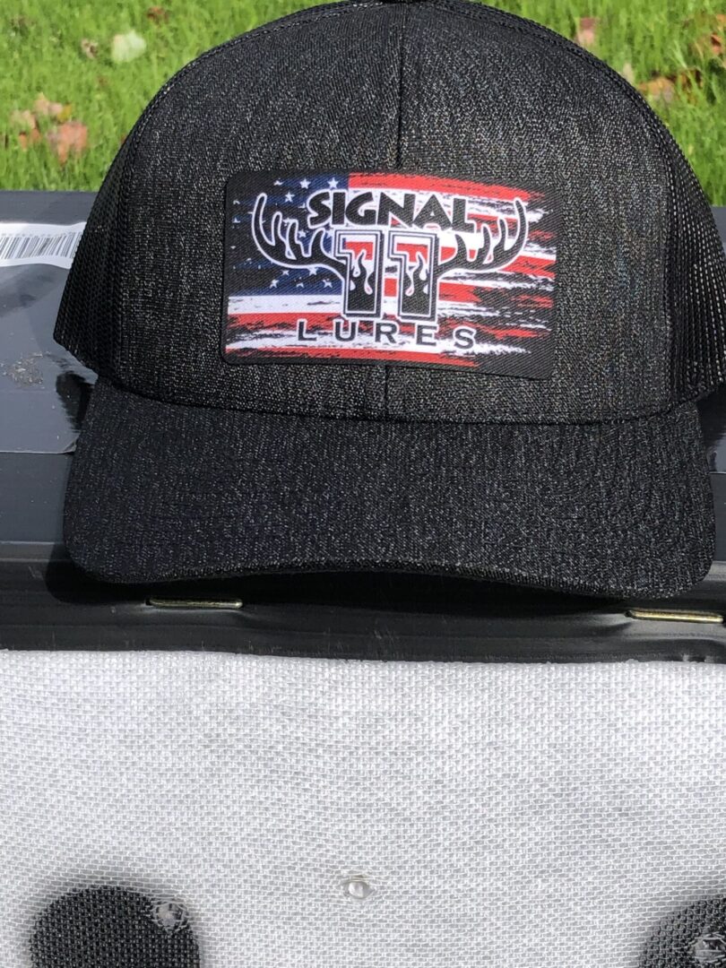A black hat with an american flag patch on it.