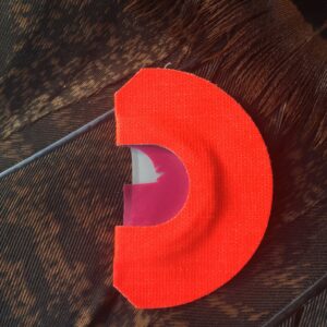 A red object is sitting on top of a table.