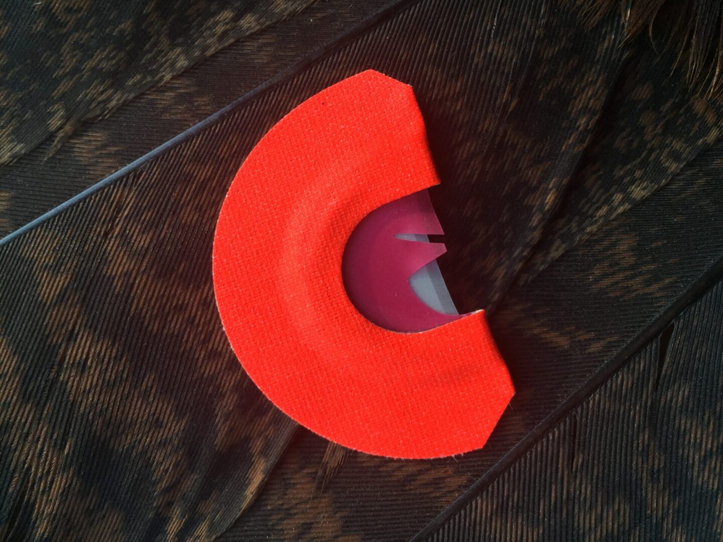 A red object is laying on the ground