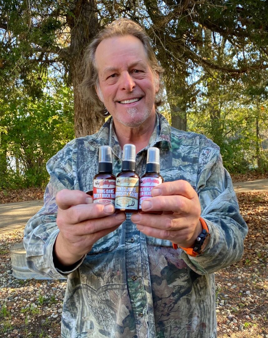 A man holding three bottles of cbd oil.