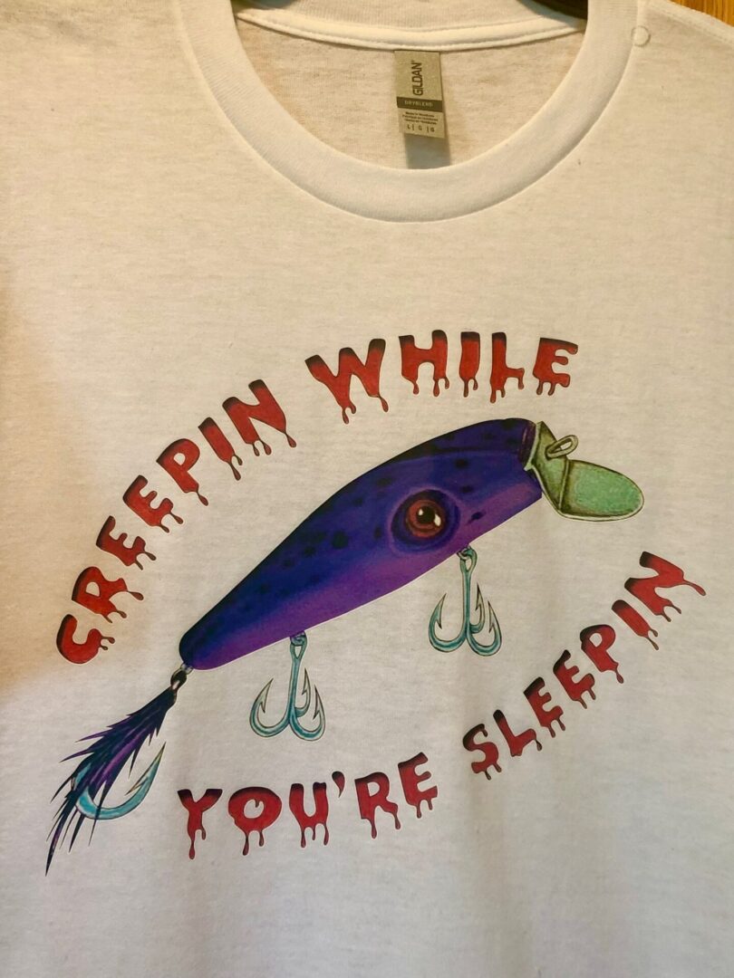 A white shirt with a purple fishing lure on it.